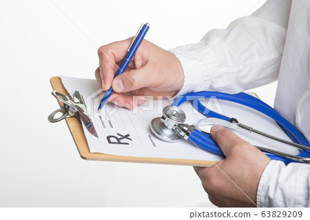 Male doctor filling patient complaints list clipped to pad. Physical, exam, disease prevention, ward round, prescribe remedy, healthy lifestyle concept. 63829209