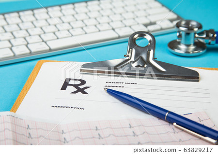 keyboard and Medical stethoscope lying on cardiogram chart closeup. Medical help, prophylaxis, disease prevention or insurance concept. Cardiology care. 63829217
