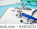 keyboard and Medical stethoscope lying on cardiogram chart closeup. Medical help, prophylaxis, disease prevention or insurance concept. Cardiology care. 63829232