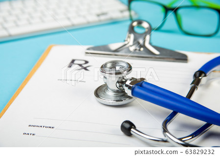 keyboard and Medical stethoscope lying on cardiogram chart closeup. Medical help, prophylaxis, disease prevention or insurance concept. Cardiology care. 63829232