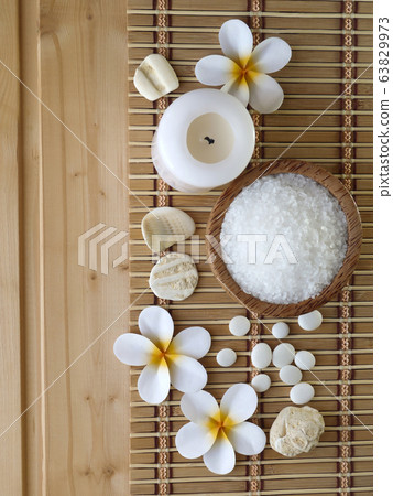 Salt,shells and tiare flowers on the wooden 63829973