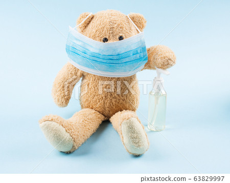 Teddy bear wearing medical face mask. Covid-19 63829997