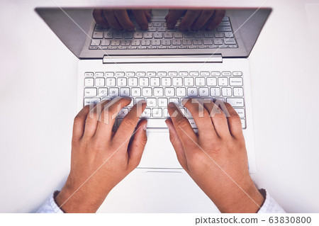 Man hand on laptop keyboard with blank screen monitor 63830800