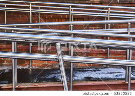 shiny handrails of a modern ramp for the disabled shiny handrails of a modern ramp for the disabled 63830825