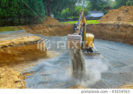 Excavator digging bucket scooping gravel from a Excavator digging bucket scooping gravel from a 63834563