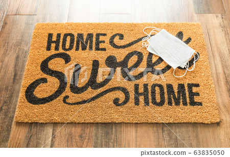 Several Medical Face Mask Rests on Home Sweet Home Mat 63835050