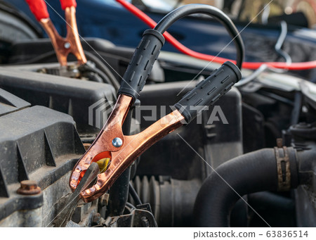 Jump cables on car battery Jump cables on car battery 63836514