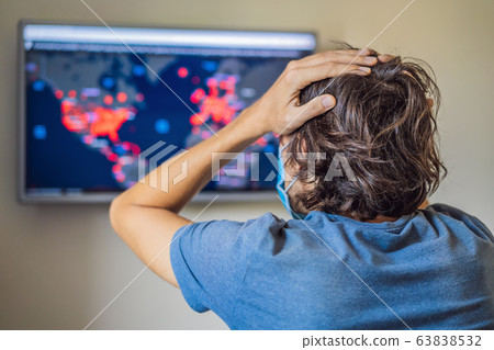 Young man checks coronavirus sars-cov-2 covid-19 global cases situation online. Coronavirus outbreak 63838532