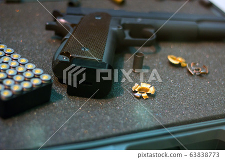Cartridges Pistol. The gun is next to the cartridges. Weapon Suitcase for the gun. Buying weapons. Cartridges of different calibers next to the gun. Weapons storage. Collectible Cartridges Pistol. The gun is next to the cartridges. Weapon Suitcase for the gun. Buying weapons. Cartridges of different calibers next to the gun. Weapons storage. Collectible 63838773