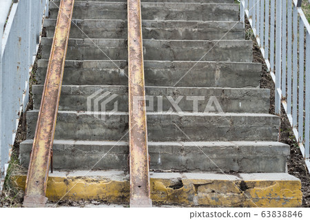 Exterior staircase with a wheelchair ramp on. Old staircase in the city Exterior staircase with a wheelchair ramp on. Old staircase in the city 63838846