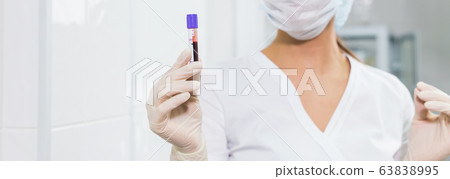 Covid-19, coronavirus, pandemic and viruses concept - woman holding blood in tests tubes close up, background with copy space. Covid-19, coronavirus, pandemic and viruses concept - woman holding blood in tests tubes close up, background with copy space. 63838995