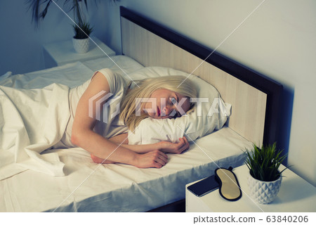 young beautiful woman at home bedroom lying in bed 63840206