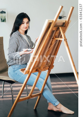 Artist at work in home studio. Woman painting Artist at work in home studio. Woman painting 63841237