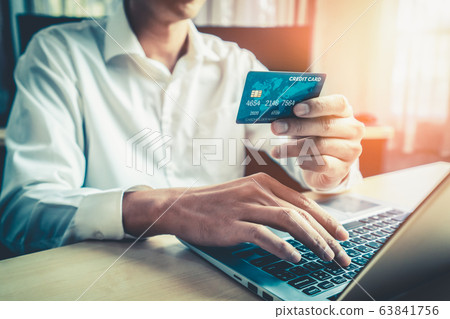 Young man use credit card for online shopping Young man use credit card for online shopping 63841756