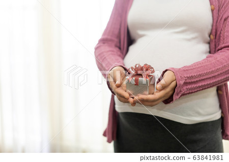 Happy pregnant woman and expecting baby at home. 63841981