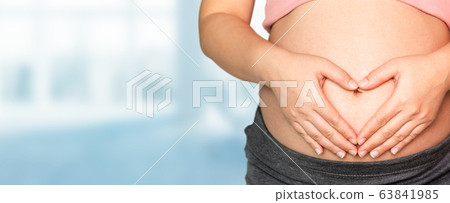 Pregnant woman at hospital health check up. Pregnant woman at hospital health check up. 63841985