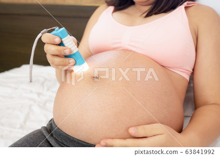 Happy pregnant woman and expecting baby at home. Happy pregnant woman and expecting baby at home. 63841992