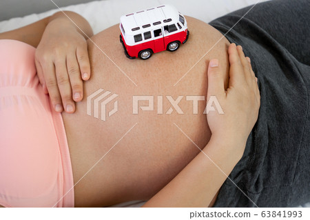 Happy pregnant woman and expecting baby at home. 63841993