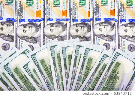 A pile of US banknotes with president portraits A pile of US banknotes with president portraits 63843712