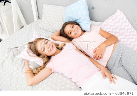 Pajama party and friendship. Sisters happy small Pajama party and friendship. Sisters happy small 63843971