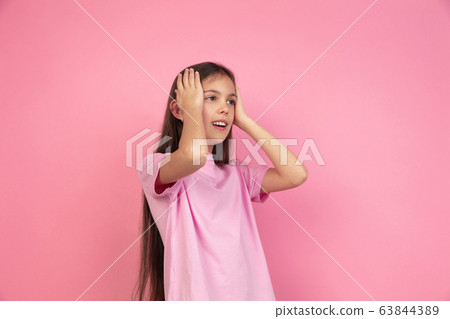 Caucasian little girl portrait isolated on pink studio background, emotions concept 63844389