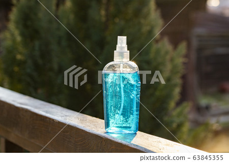 spraying hand sanitizer coronavirus prevention 63845355