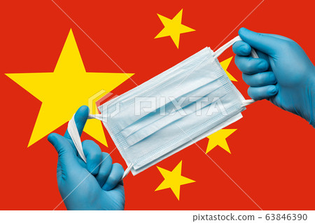 Medic holding respiratory face mask in hands in blue gloves on background flag of People's Republic of China PRC Medic holding respiratory face mask in hands in blue gloves on background flag of People's Republic of China PRC 63846390