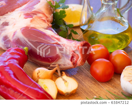 Fresh and raw meat. Leg of lamb on wood background Fresh and raw meat. Leg of lamb on wood background 63847212