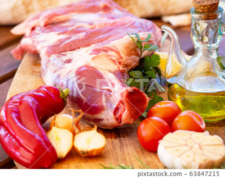 Fresh and raw meat. Leg of lamb on wood background 63847215