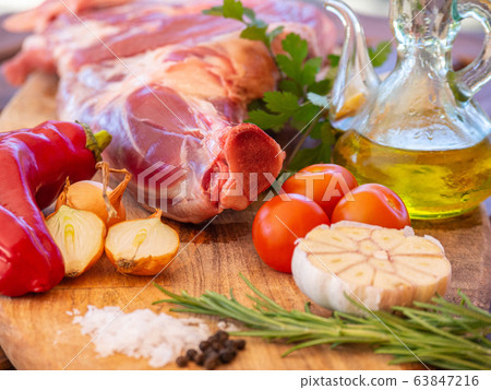 Fresh and raw meat. Leg of lamb on wood background 63847216