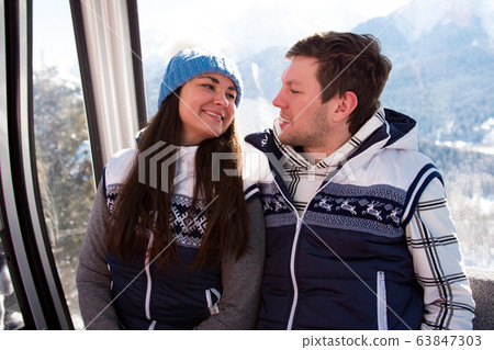 Ski lift, skiing, ski resort - happy skiers on ski lift. 63847303