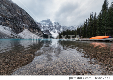 Rocky mountains with canoe on pier in Moraine Lake 63847537