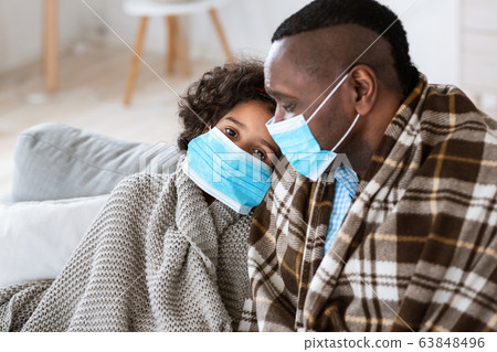 Worldwide disease outbreak. Mature man with his granddaughter wearing medical masks at home Worldwide disease outbreak. Mature man with his granddaughter wearing medical masks at home 63848496