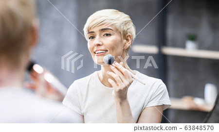 Middle-Aged Lady Applying Face Powder With Cosmetic Brush Indoors, Panorama Middle-Aged Lady Applying Face Powder With Cosmetic Brush Indoors, Panorama 63848570