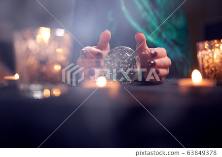 Close-up of fortuneteller woman's hands with predictions ball 63849378