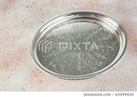 Antique silver plated tray on concrete background. Antique silver plated tray on concrete background. 63849930