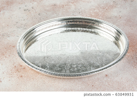 Antique silver plated tray on concrete background. Antique silver plated tray on concrete background. 63849931