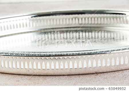 Antique silver plated tray on concrete background. 63849932