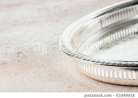 Antique silver plated tray on concrete background. Antique silver plated tray on concrete background. 63849938