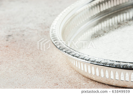 Antique silver plated tray on concrete background. Antique silver plated tray on concrete background. 63849939