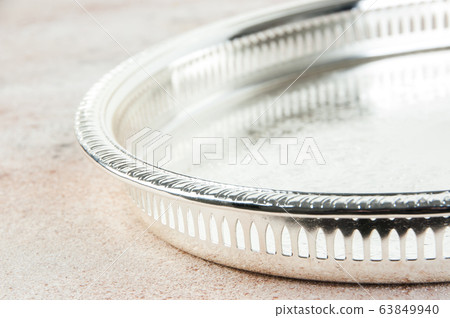 Antique silver plated tray on concrete background. Antique silver plated tray on concrete background. 63849940