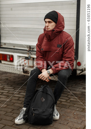 Fashionable stylish young man in a red jacket Fashionable stylish young man in a red jacket 63851196