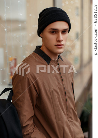 young stylish man in a fashion vintage coat 63851218