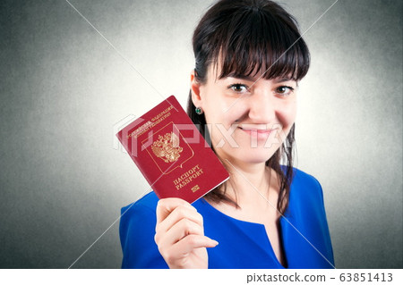 Russian passport in the hand of woman 63851413