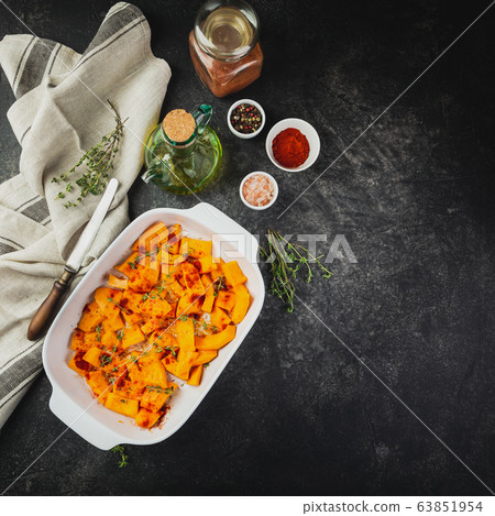Roasted pumpkin slices with thyme 63851954