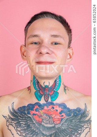 Portrait of young man with freaky appearance on pink background 63852024