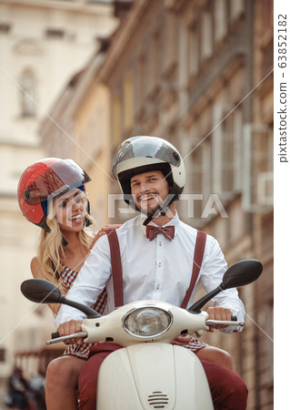young beautiful hipster couple riding on motorbike 63852182