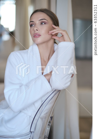 woman resting in a bathrobe at home woman resting in a bathrobe at home 63852311