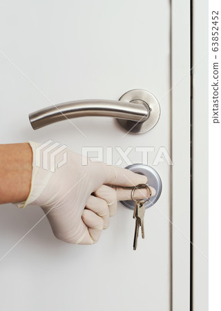 man opening a door wearing latex gloves man opening a door wearing latex gloves 63852452