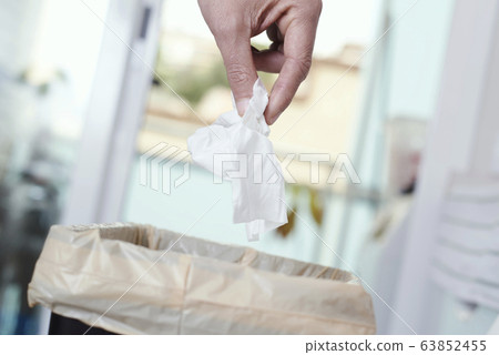 man throwing a used wet wipe to the trash bin man throwing a used wet wipe to the trash bin 63852455